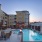 a pool and chairs next to a building