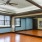 a room with a wood floor and a mirror