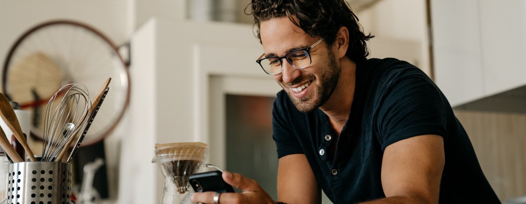 man on cell phone in a kitchen